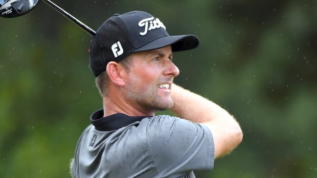 Golfer Webb Simpson holding a golf club